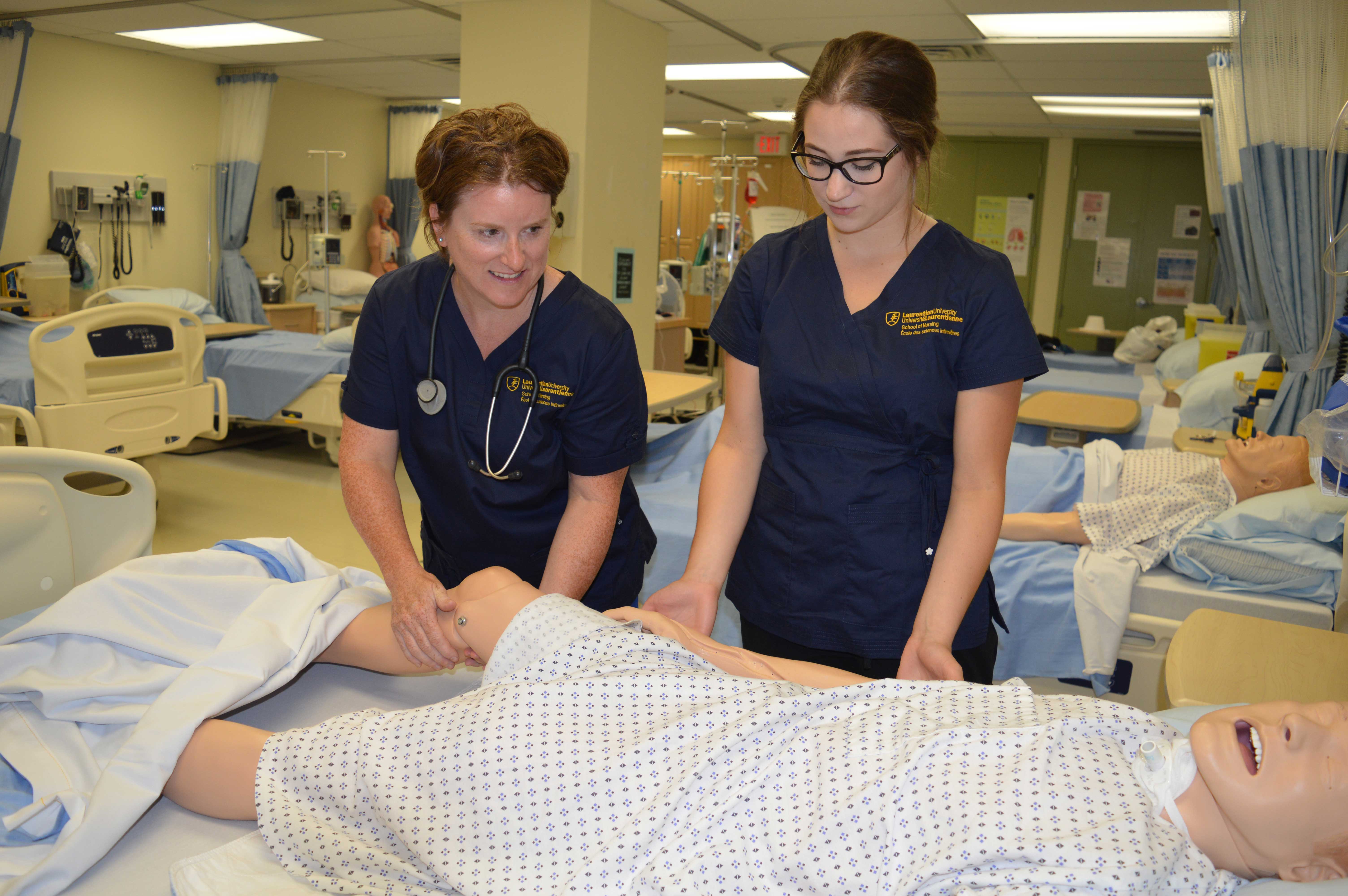 Nursing students practicing on a dummy